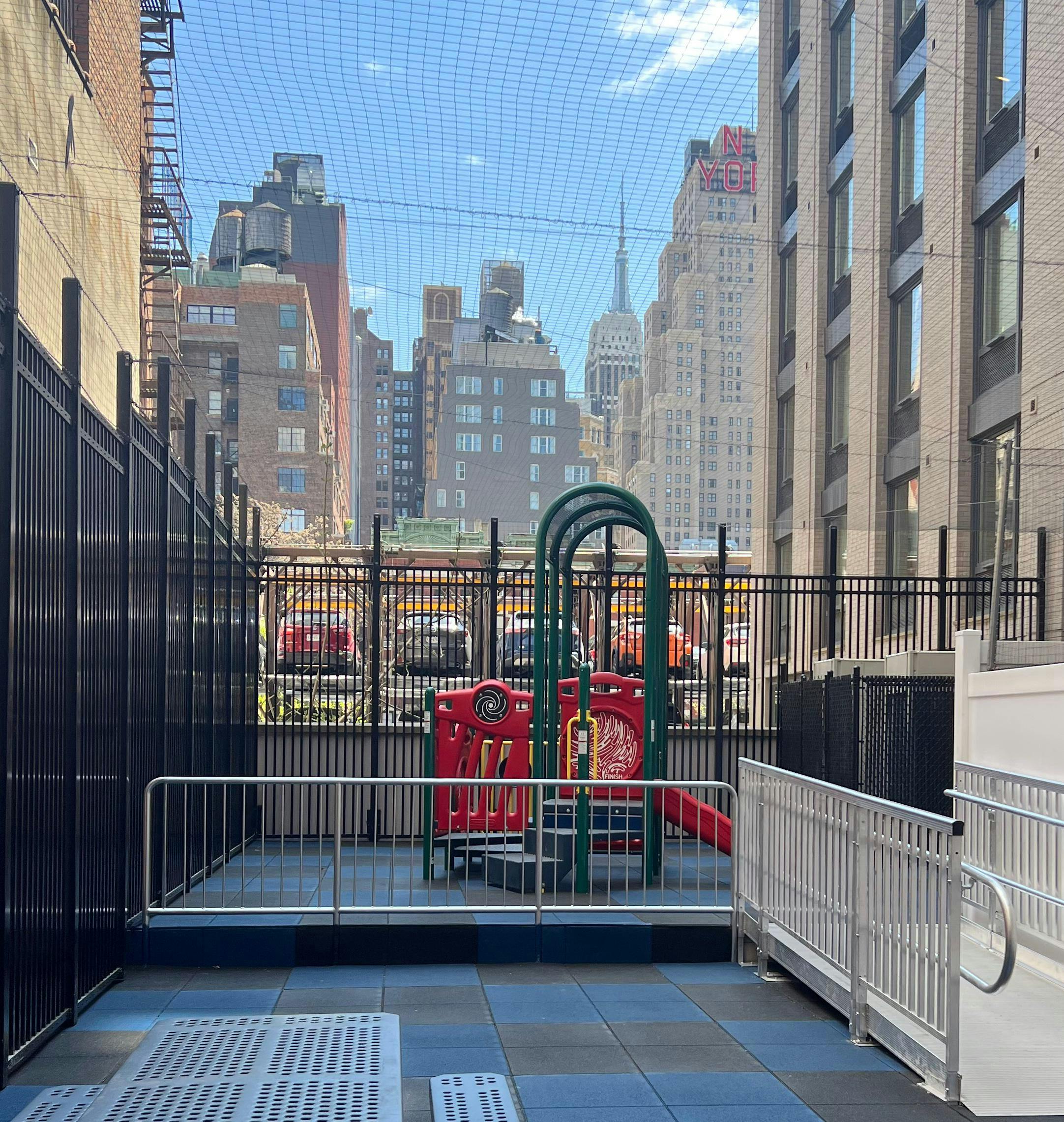 Playground with red and green equipment in an urban setting