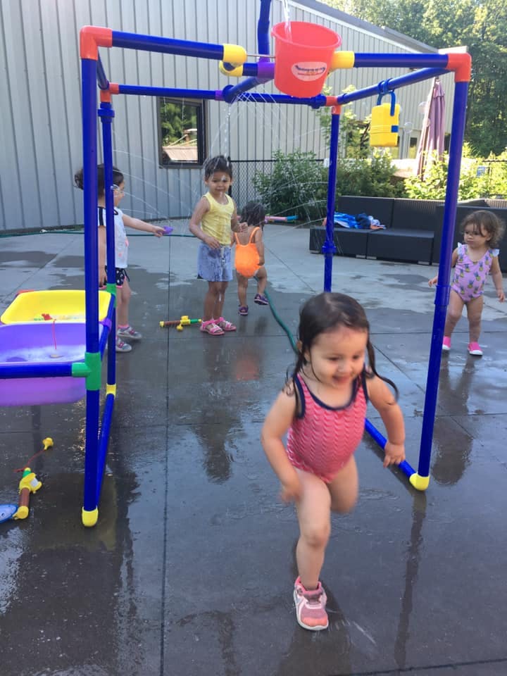 Children playing with a water toy outdoors
