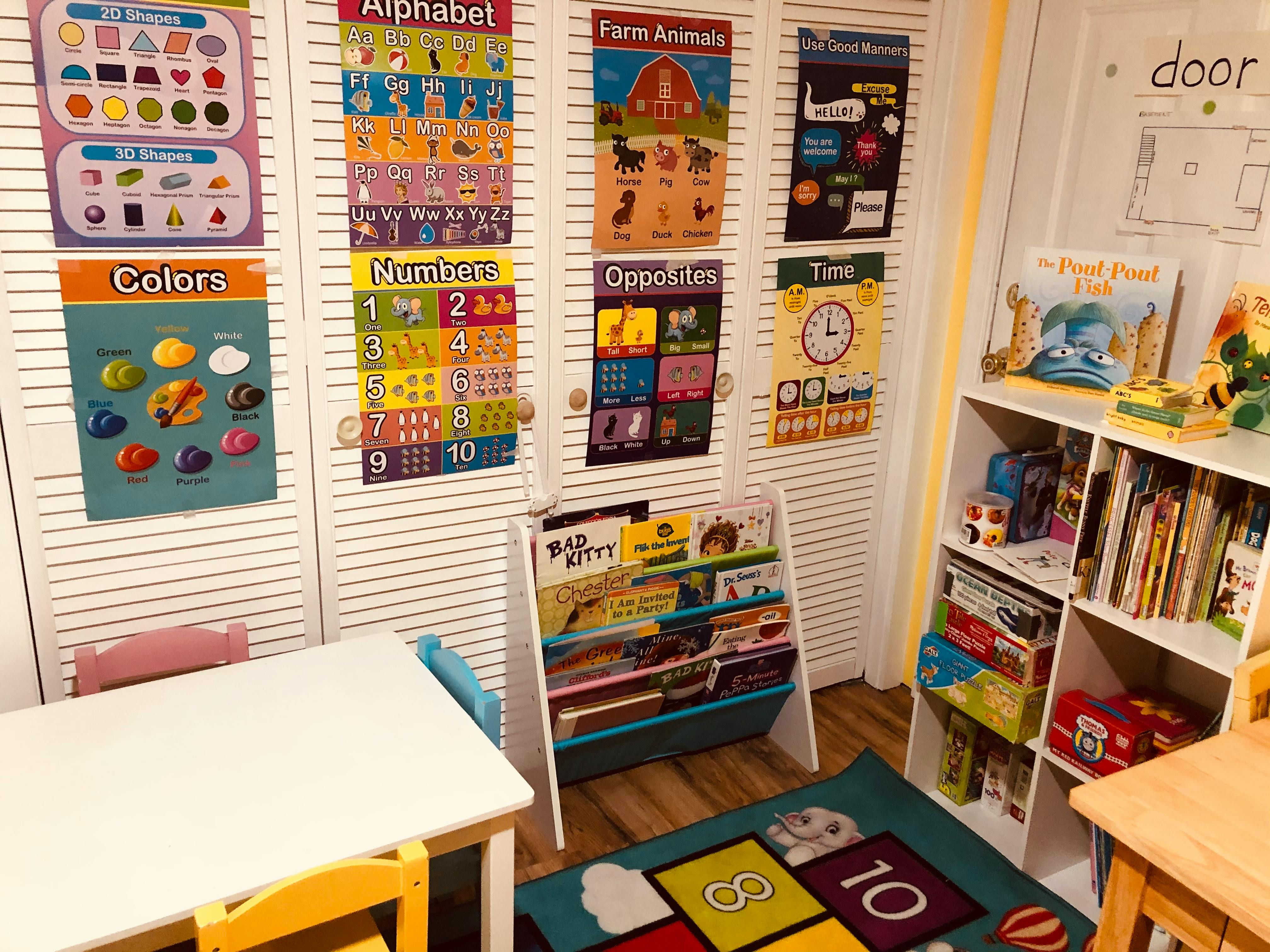 Children's learning space with educational posters, books, and small tables