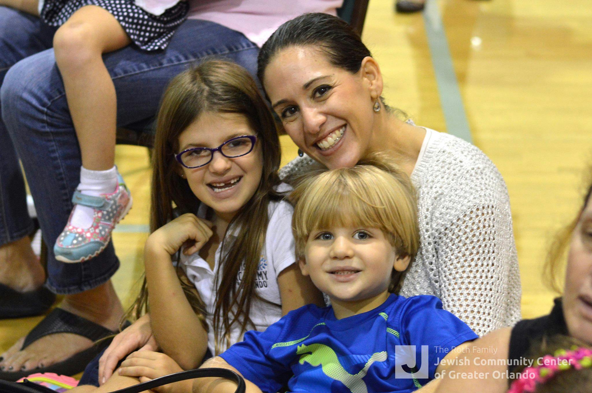 Adult and two children smiling