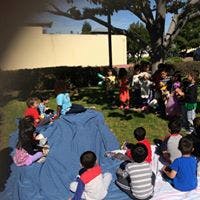 Children sitting on blankets outdoors