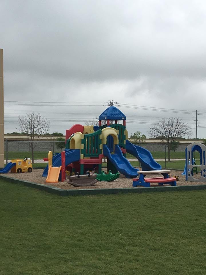 Colorful playground structure with slides and climbing areas on a cloudy day