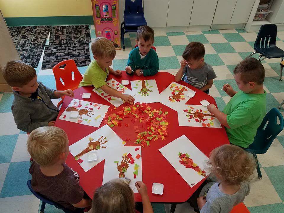 Children making art at a table