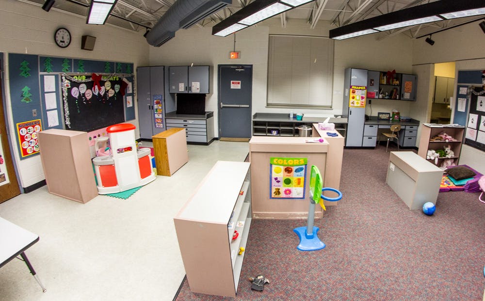 Empty classroom with play areas and storage units