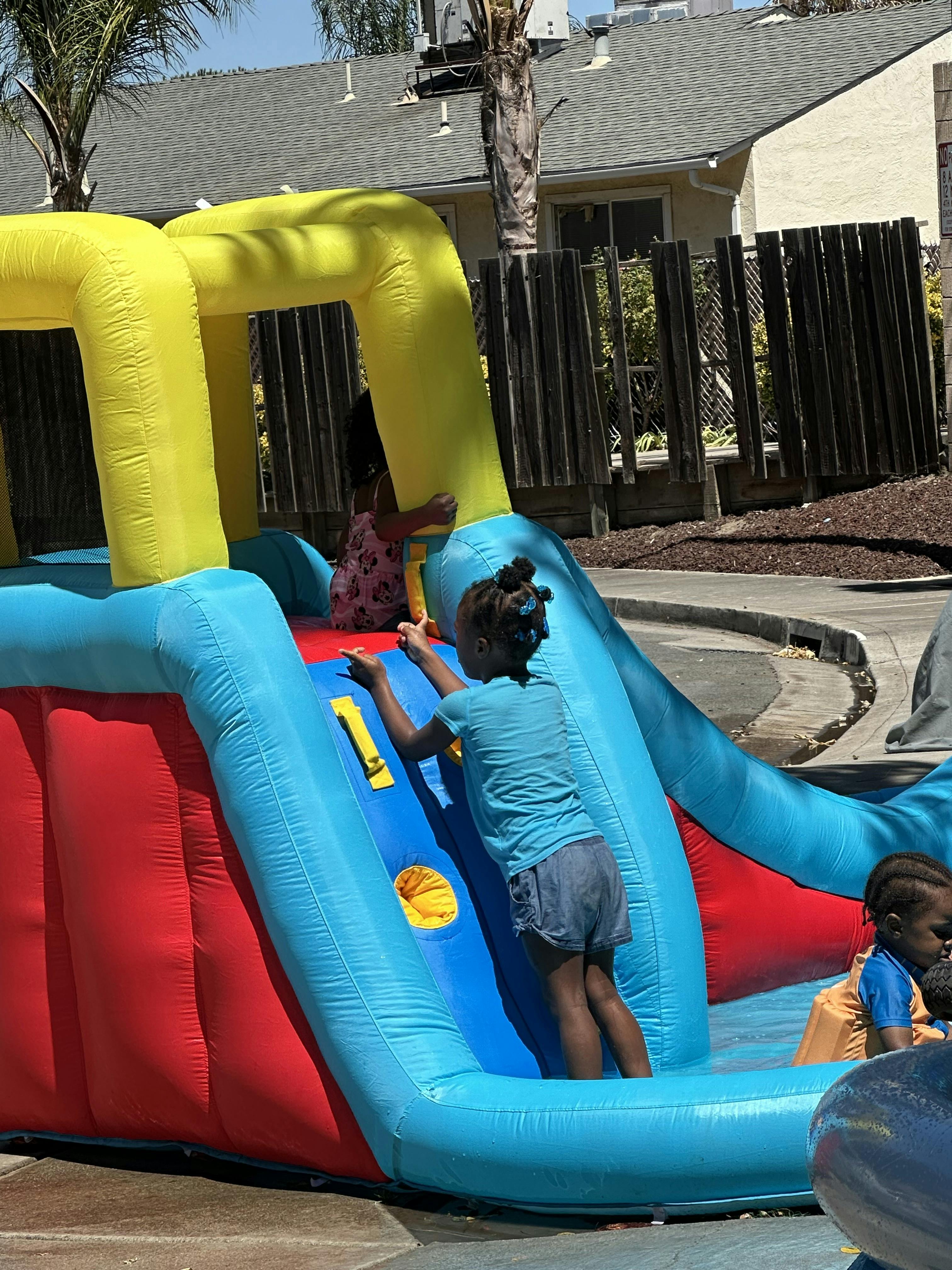 Child climbing an inflatable slide