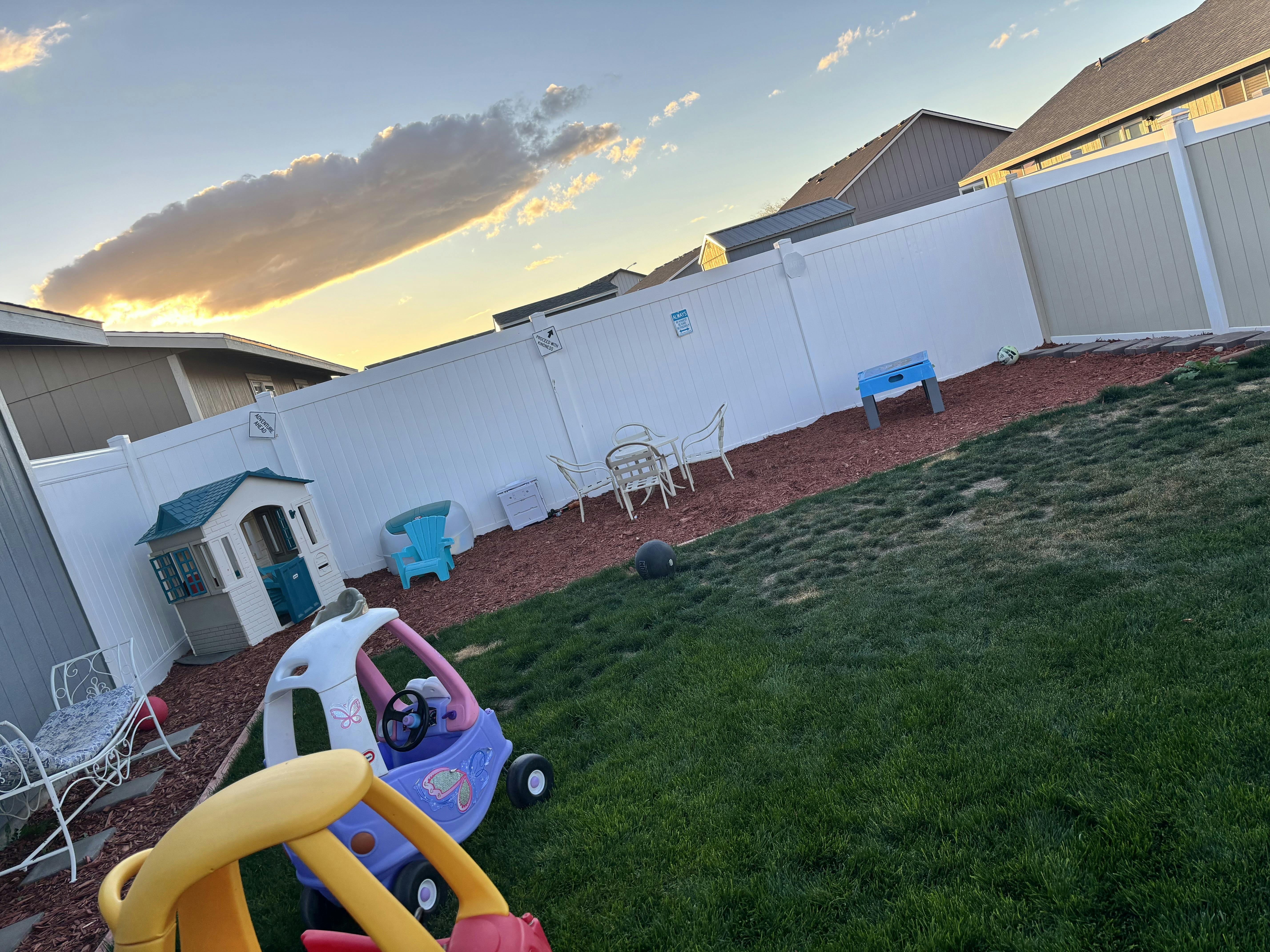 Backyard with playhouse and toy cars