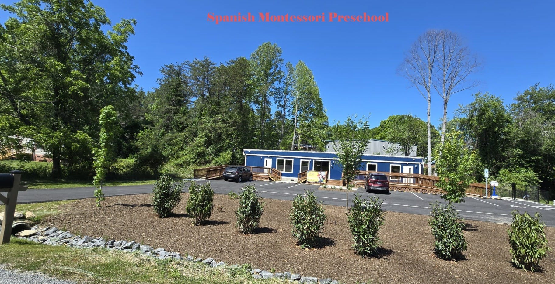 Spanish Montessori Preschool building with parking lot and trees