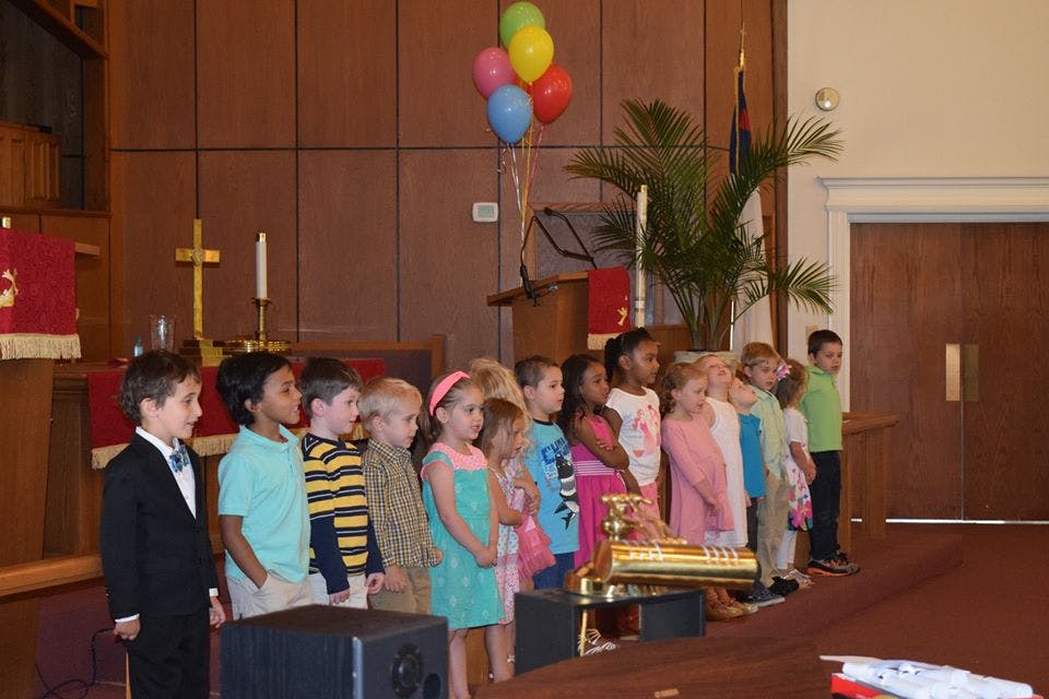 Group of children standing in a line indoors