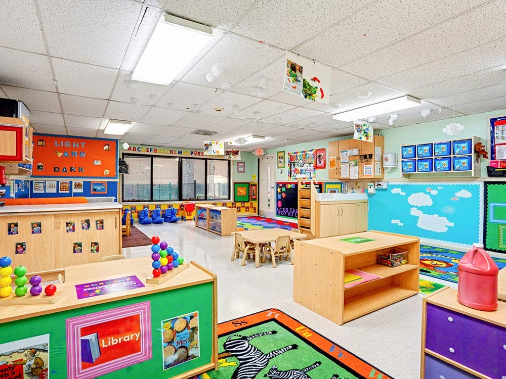 Colorful classroom with small tables, chairs, and learning materials