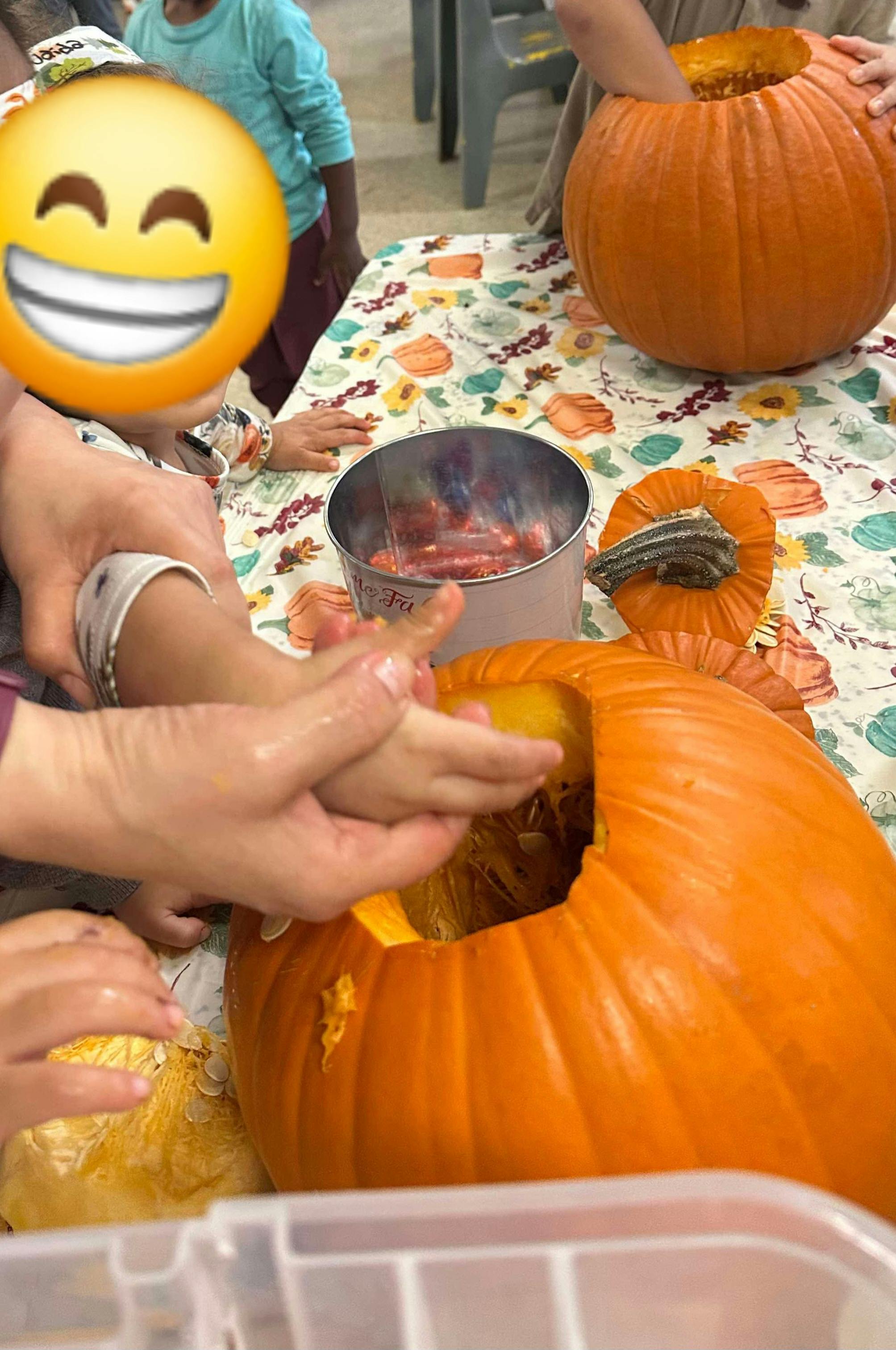 People carving pumpkins on a table