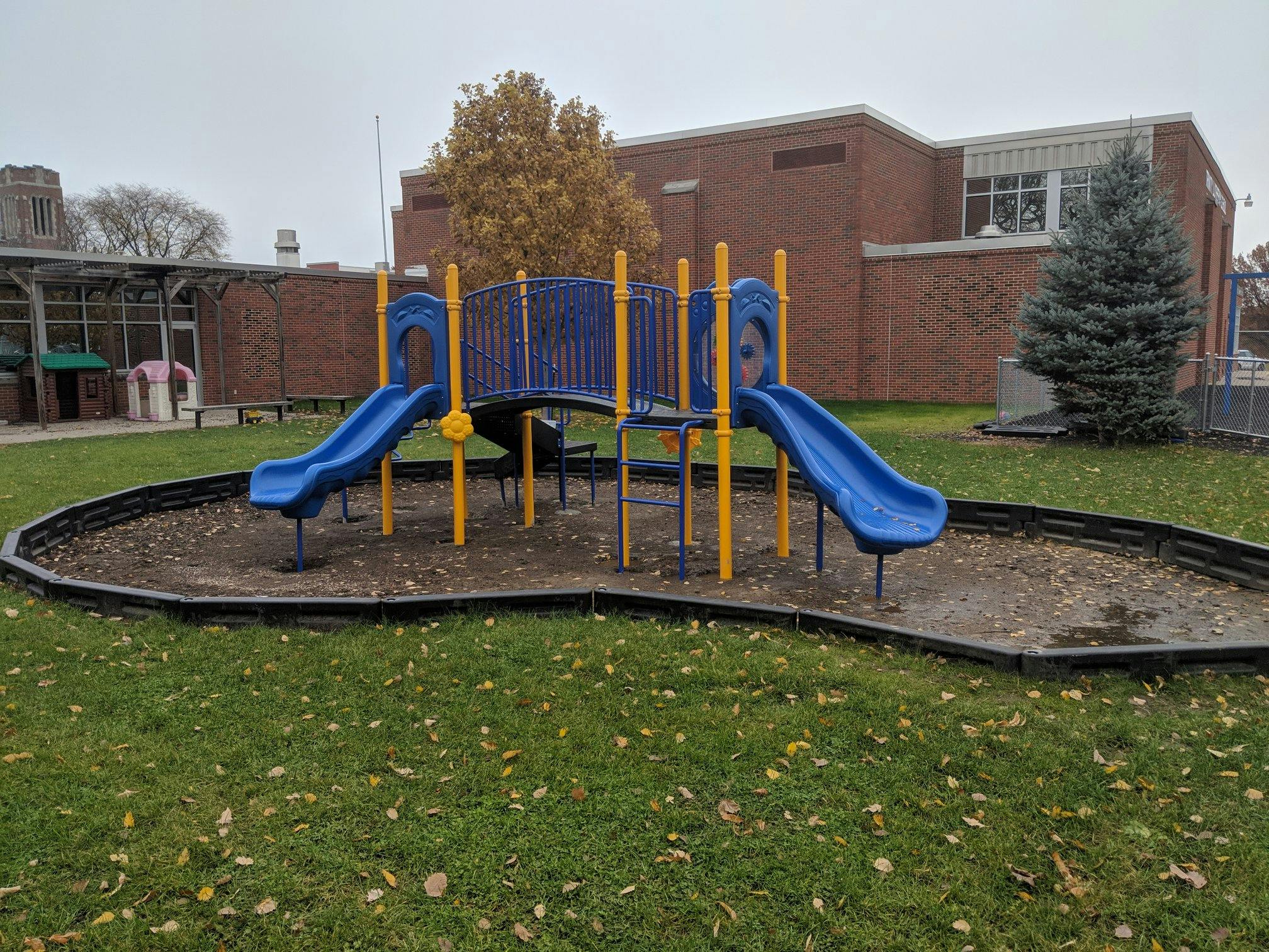 Blue and yellow playground structure with two slides