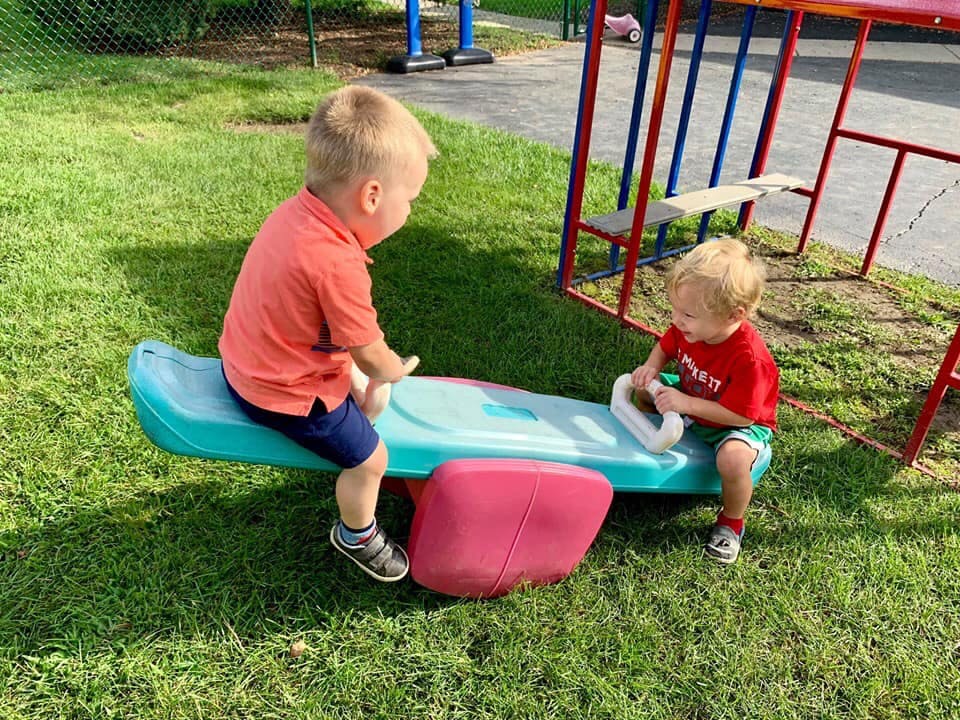 Two children playing on a seesaw