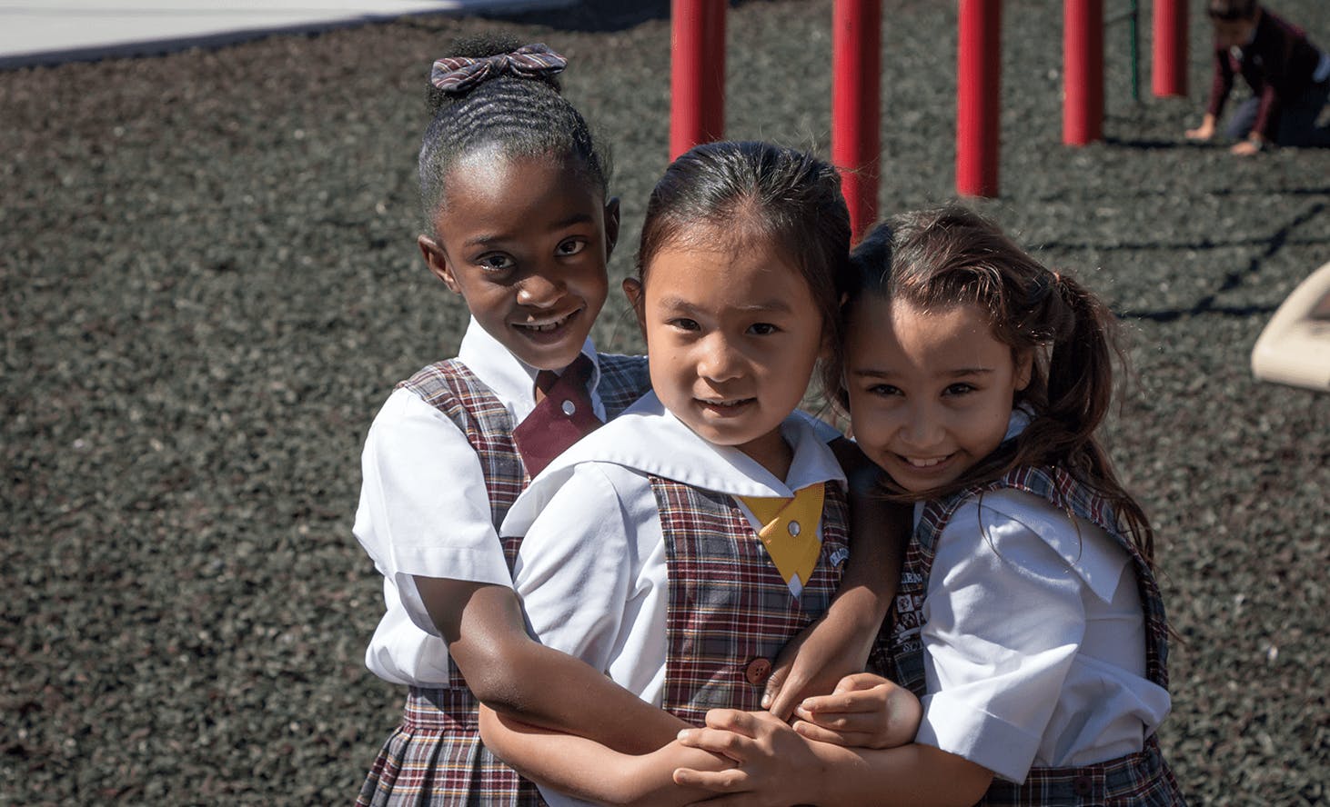 Three children in school uniforms