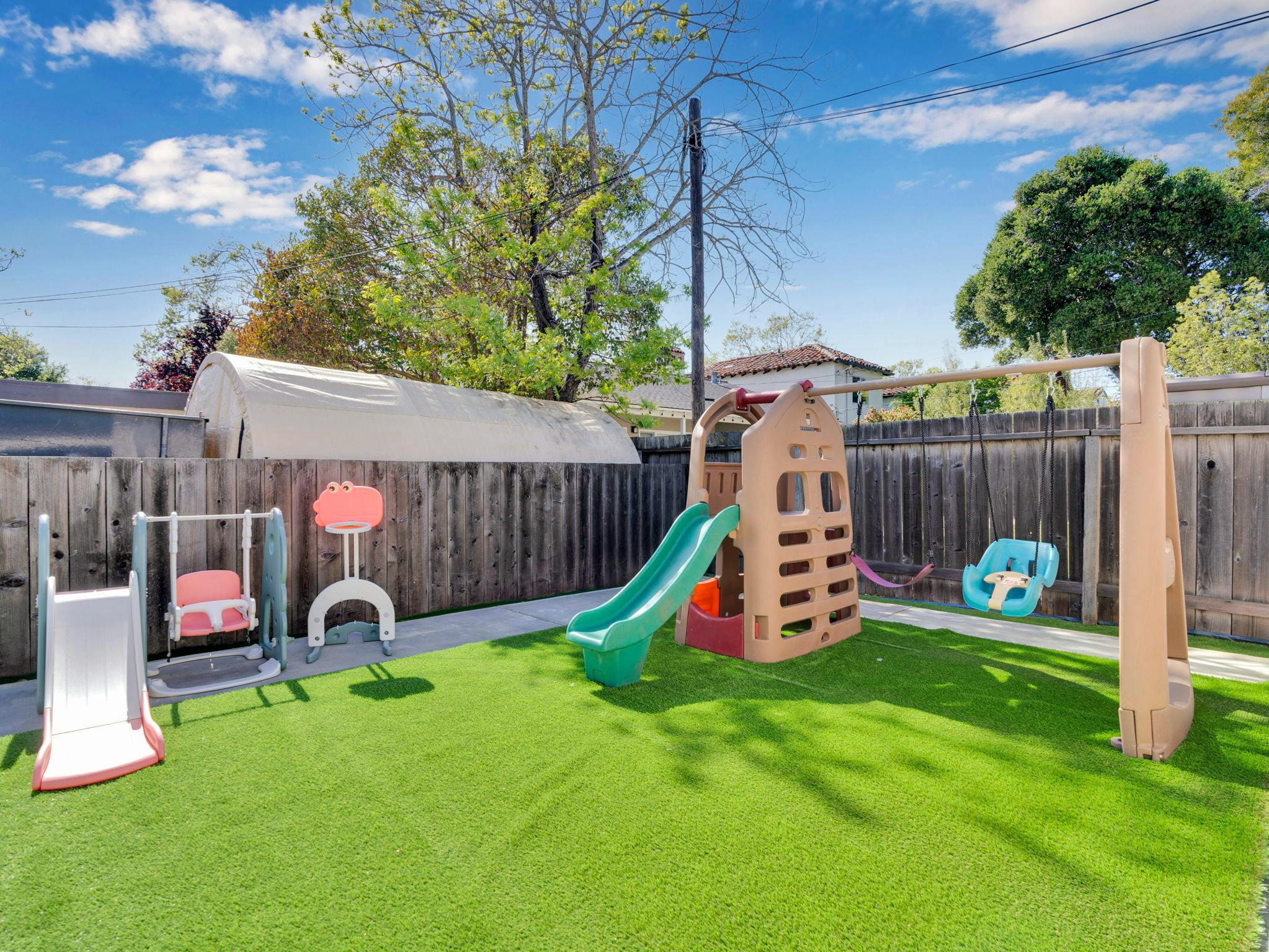 Playground with slides and swings on artificial turf