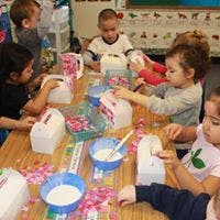 Children at a table with craft supplies