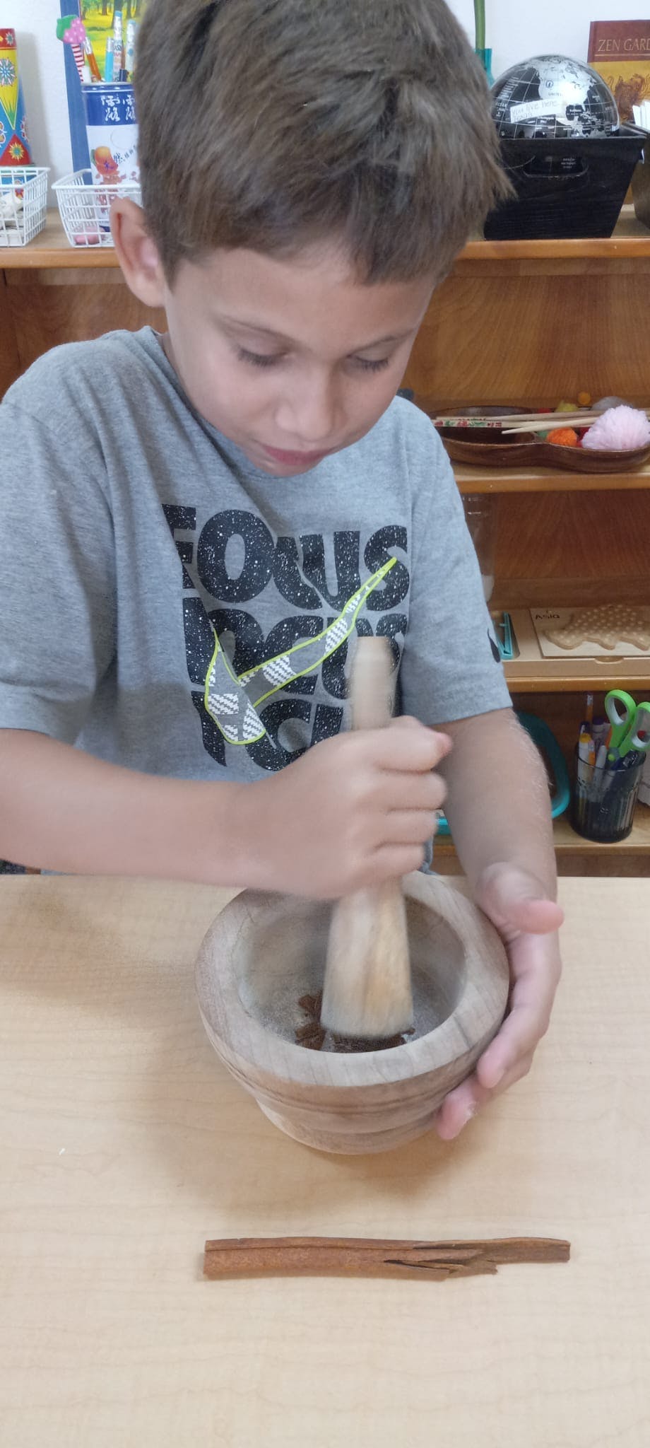 Child using a mortar and pestle