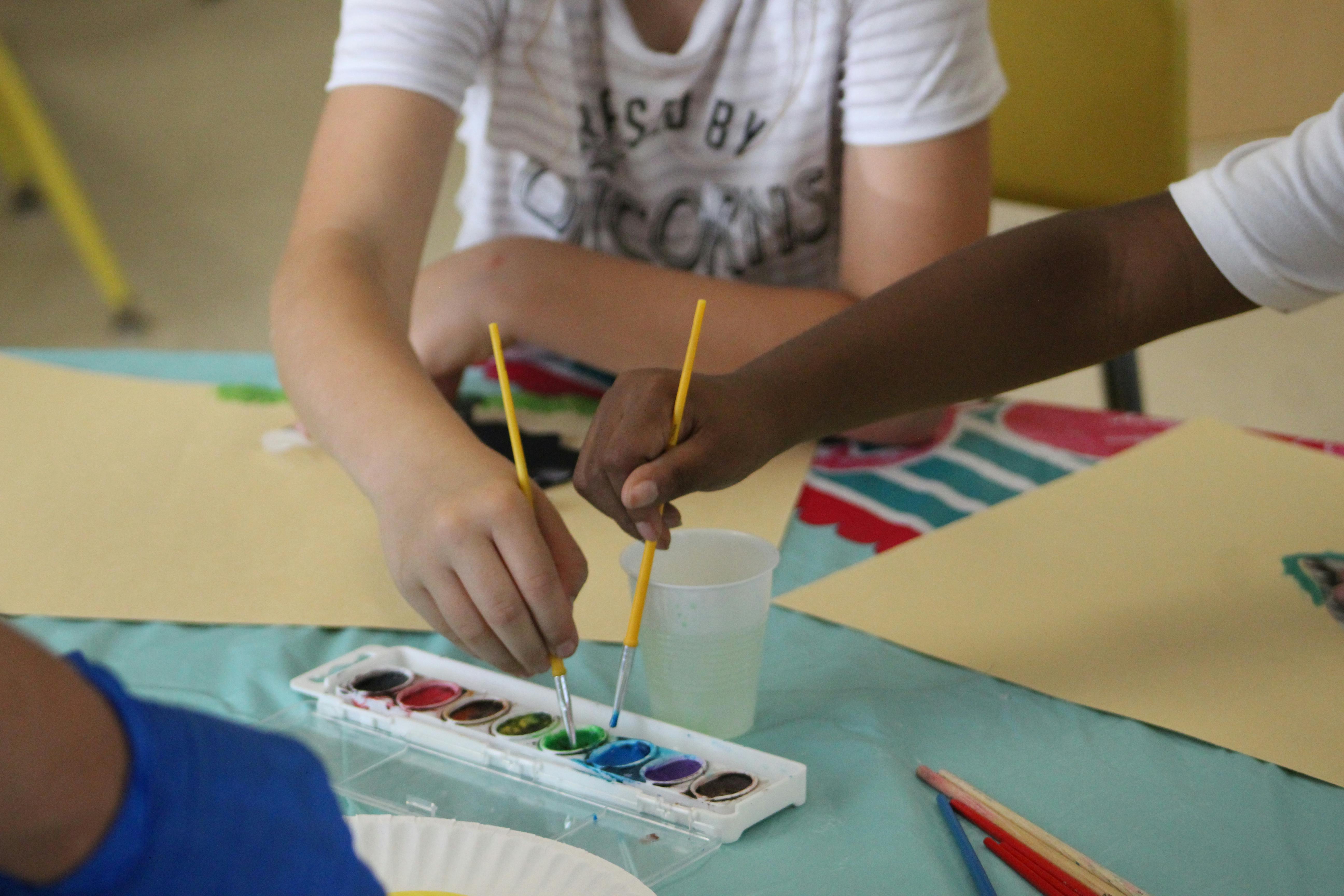 Two people painting with watercolors