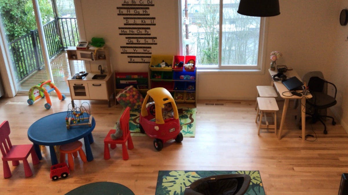 Playroom with small table and chairs, toy car, and shelves