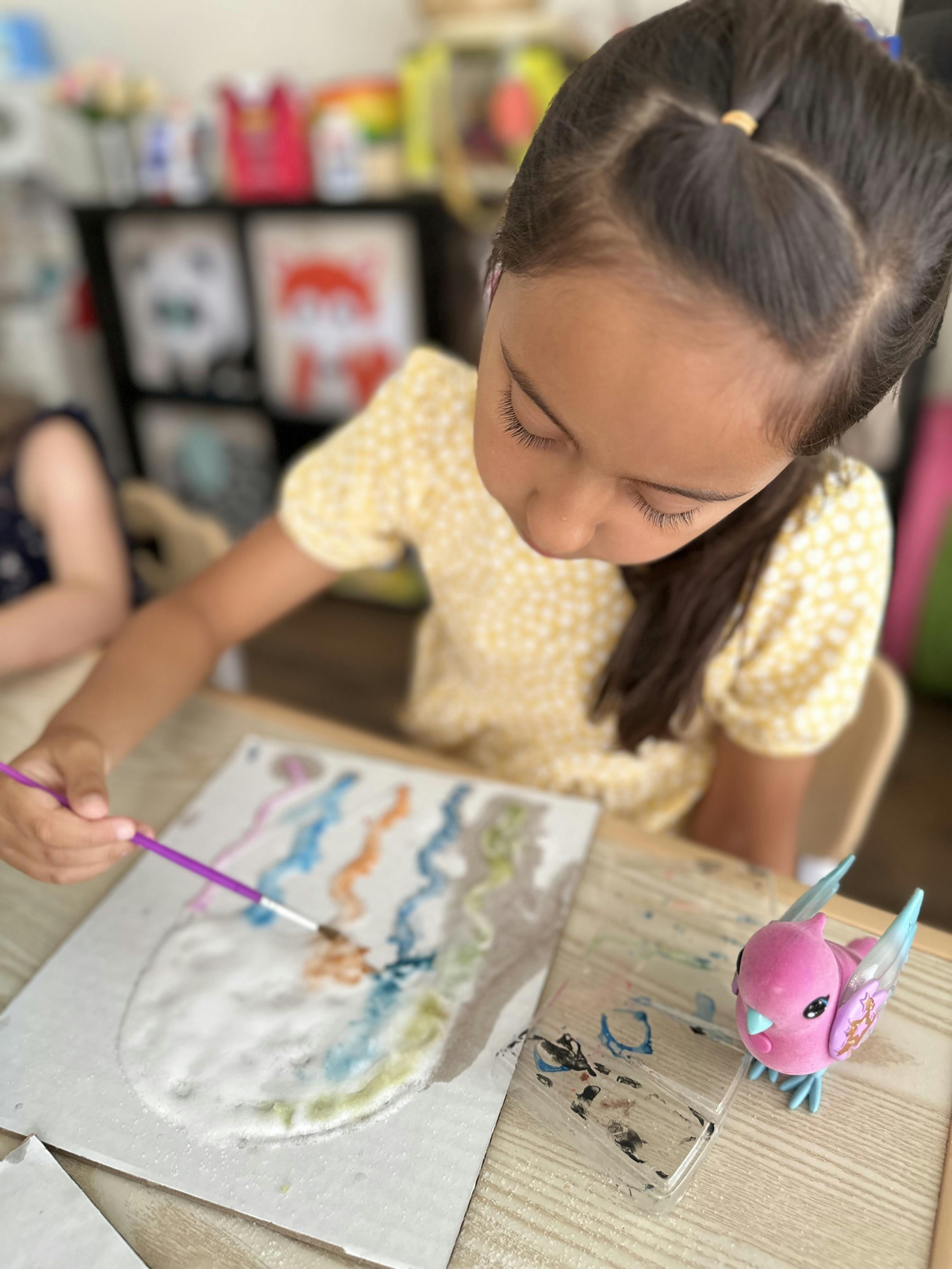 Child painting on a canvas with a brush