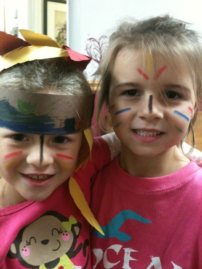 Two children with face paint and headwear