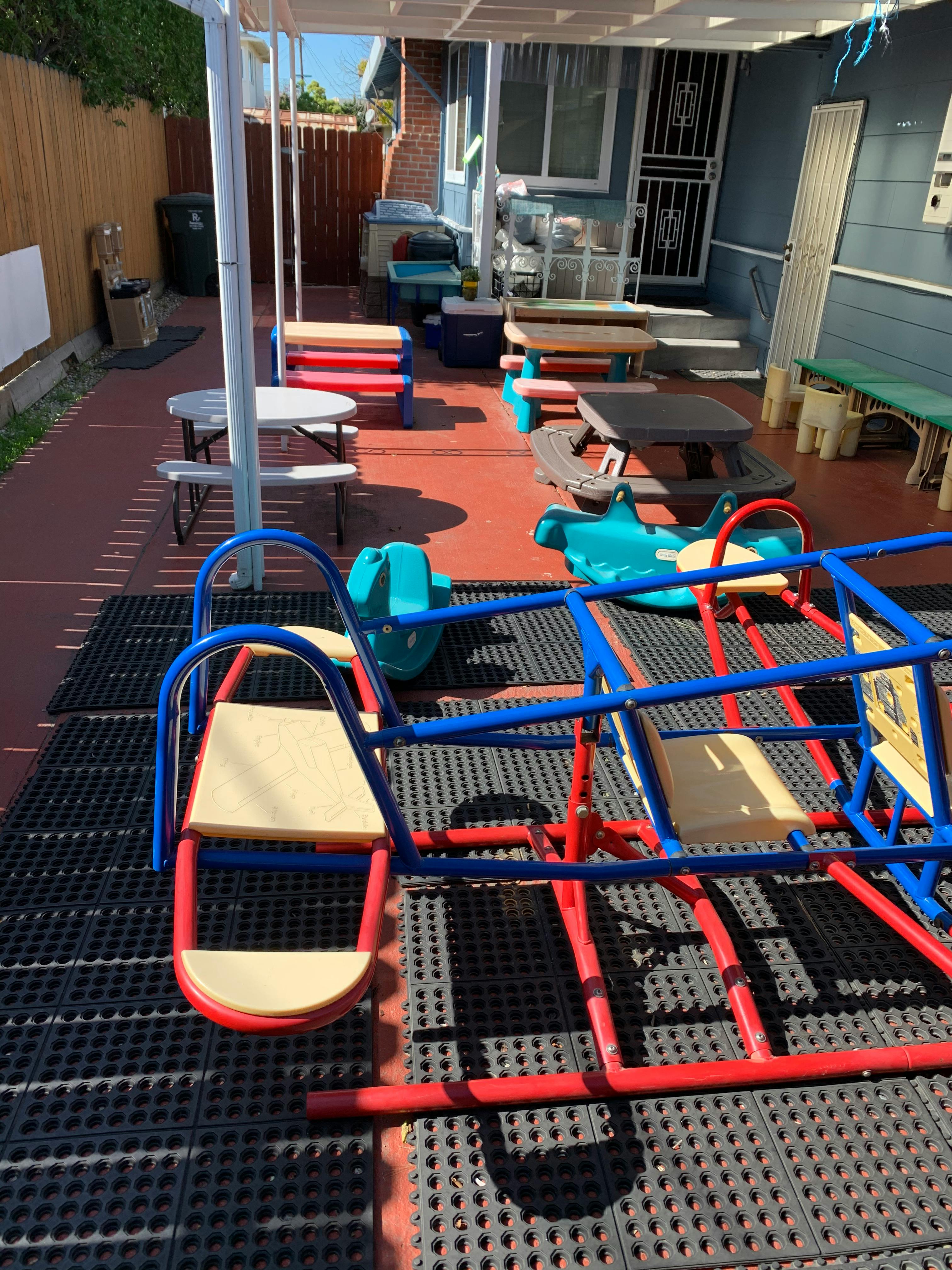 Outdoor play area with seesaw and picnic tables