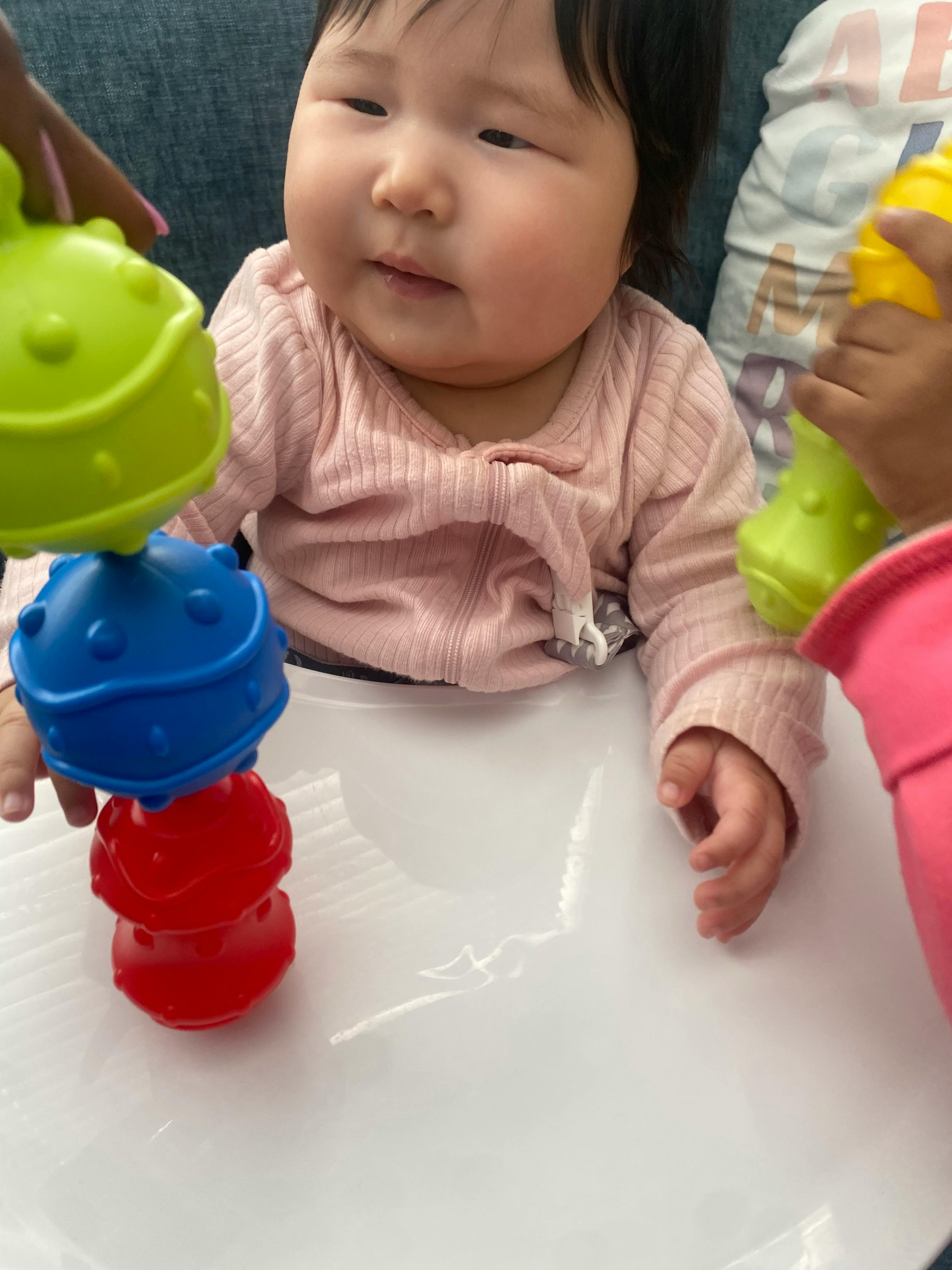 Child playing with stacking toys