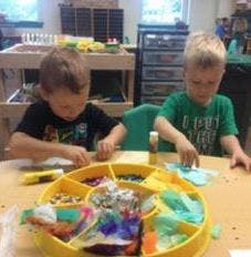 Two children doing crafts at a table