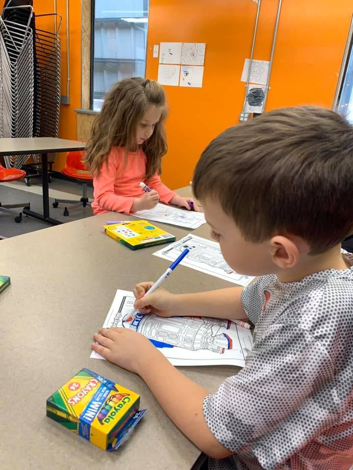Two children coloring at a table