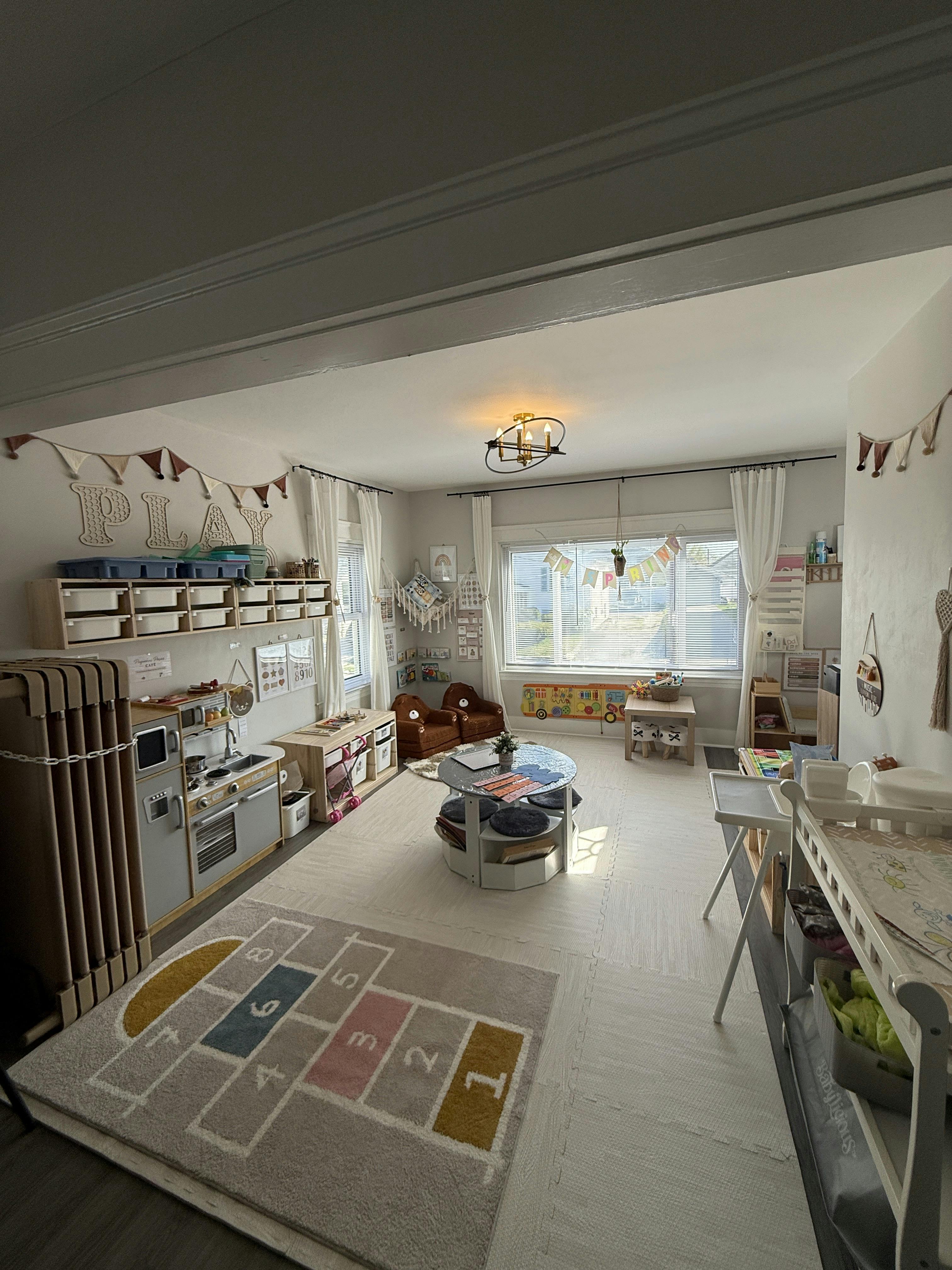 Child's playroom with play kitchen furniture toys and hopscotch rug