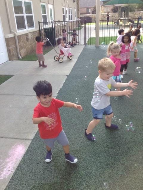 Children playing with bubbles outdoors