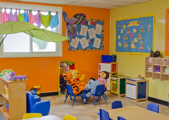 Playroom with stuffed animals sitting at a small table