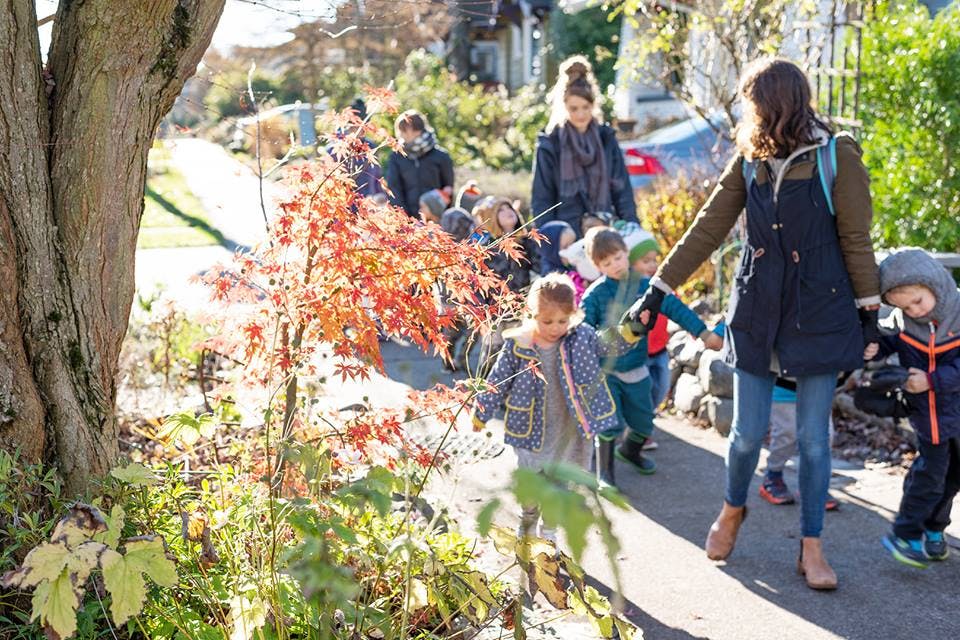 Adults and children walking on a path outdoors