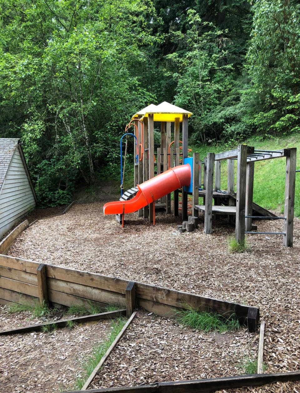 Playground with a red slide and monkey bars