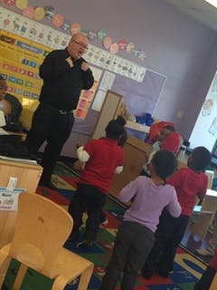 Adult speaking to children in a classroom