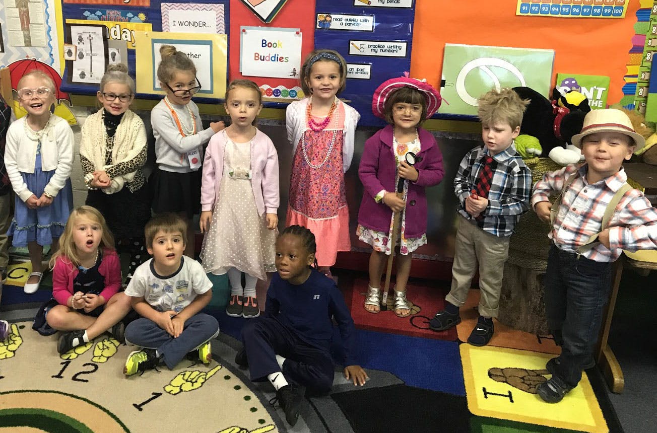 Group of children dressed in costumes in a classroom