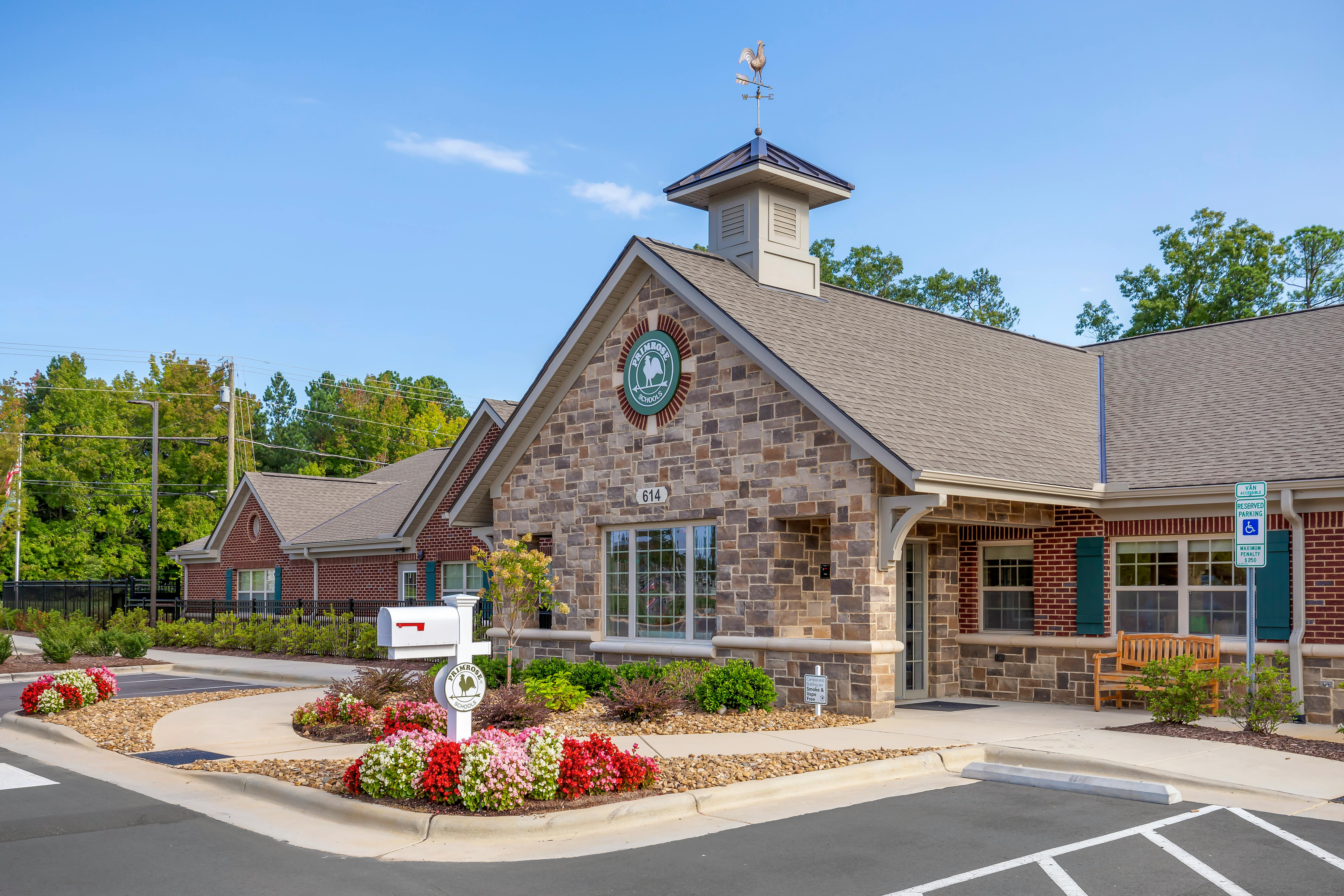 Exterior of a Primrose Schools building with landscaping and a parking lot