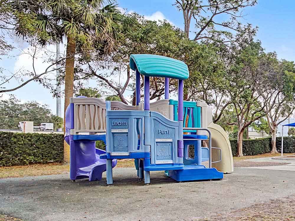 A colorful plastic playground structure in a park