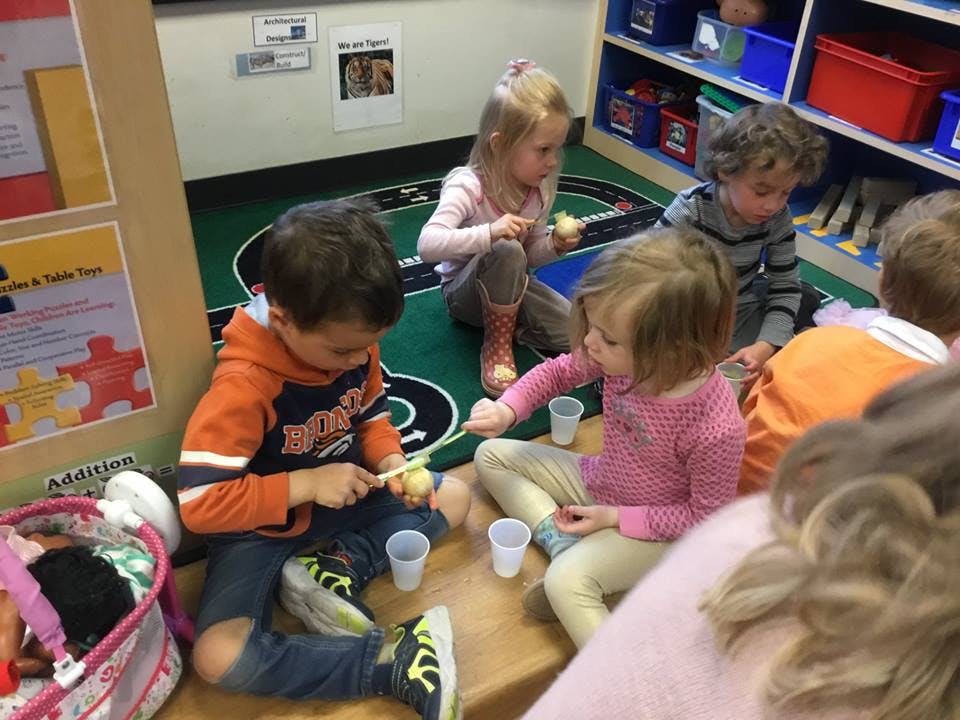 Children sitting on the floor in a classroom