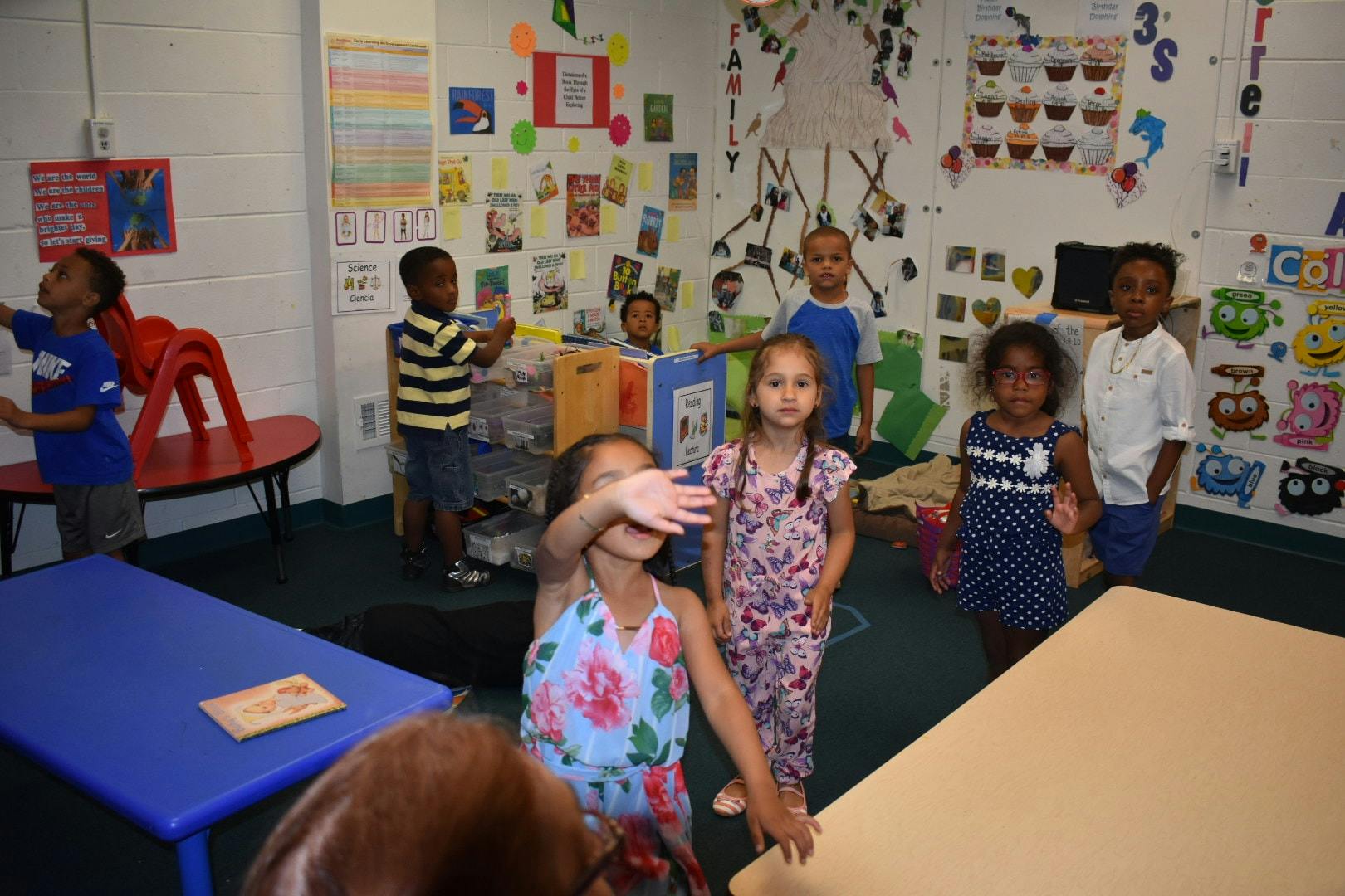 Children standing in a classroom