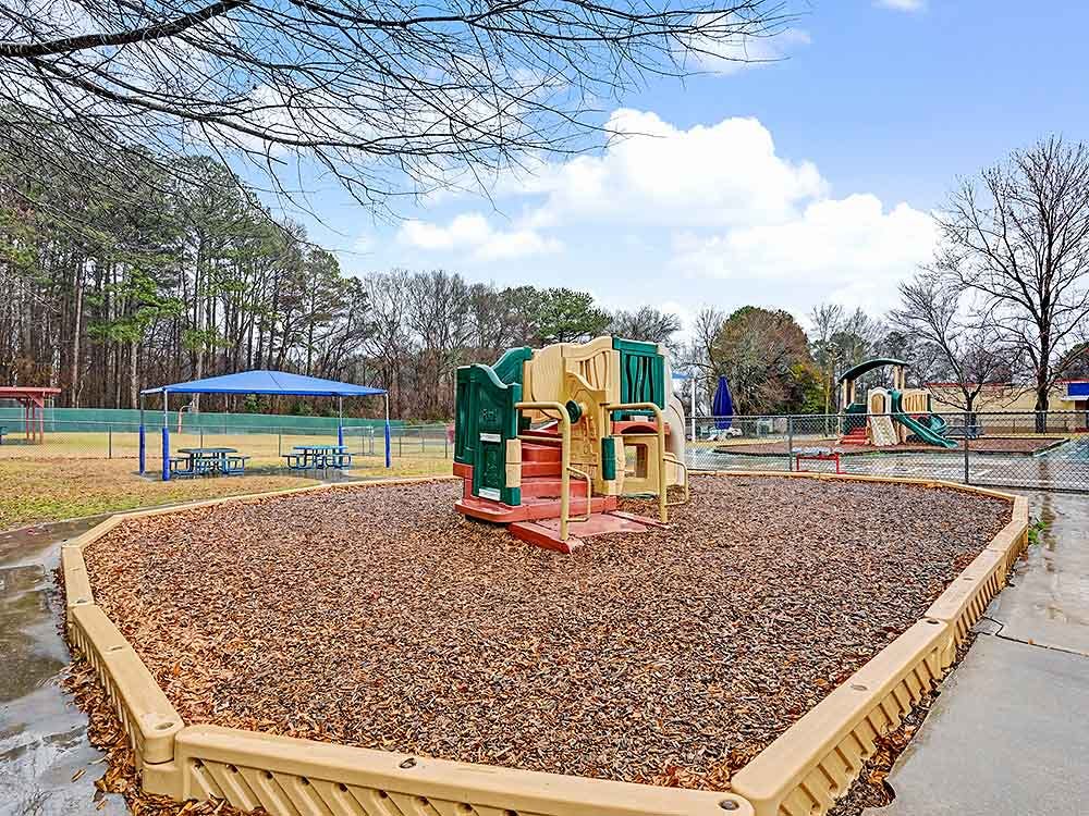 Playground with climbing structure and wood chip ground cover