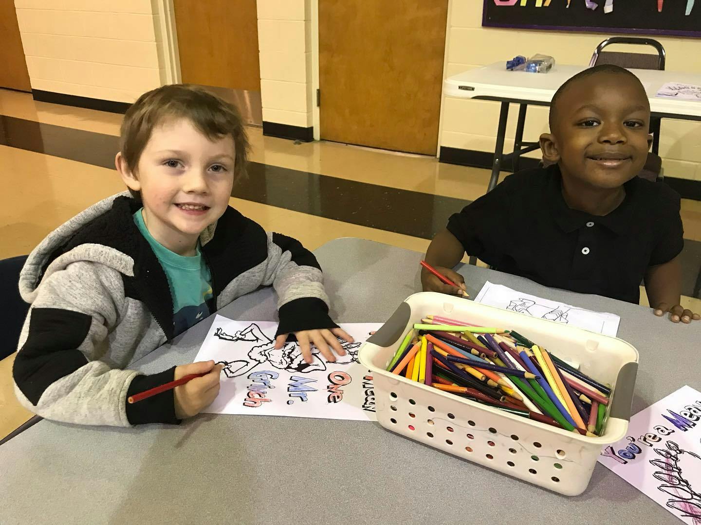 Two children coloring at a table