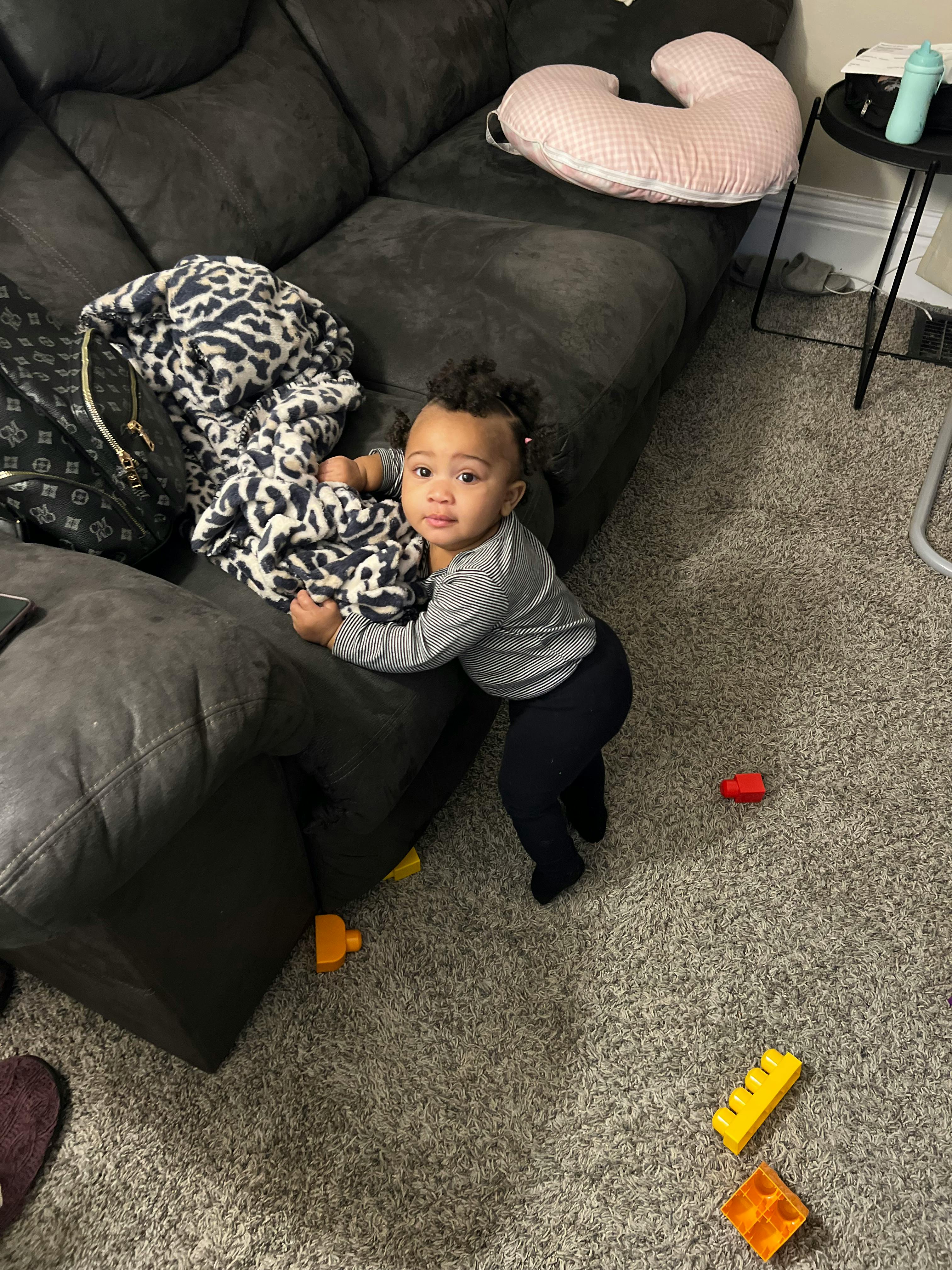 Child standing next to a couch