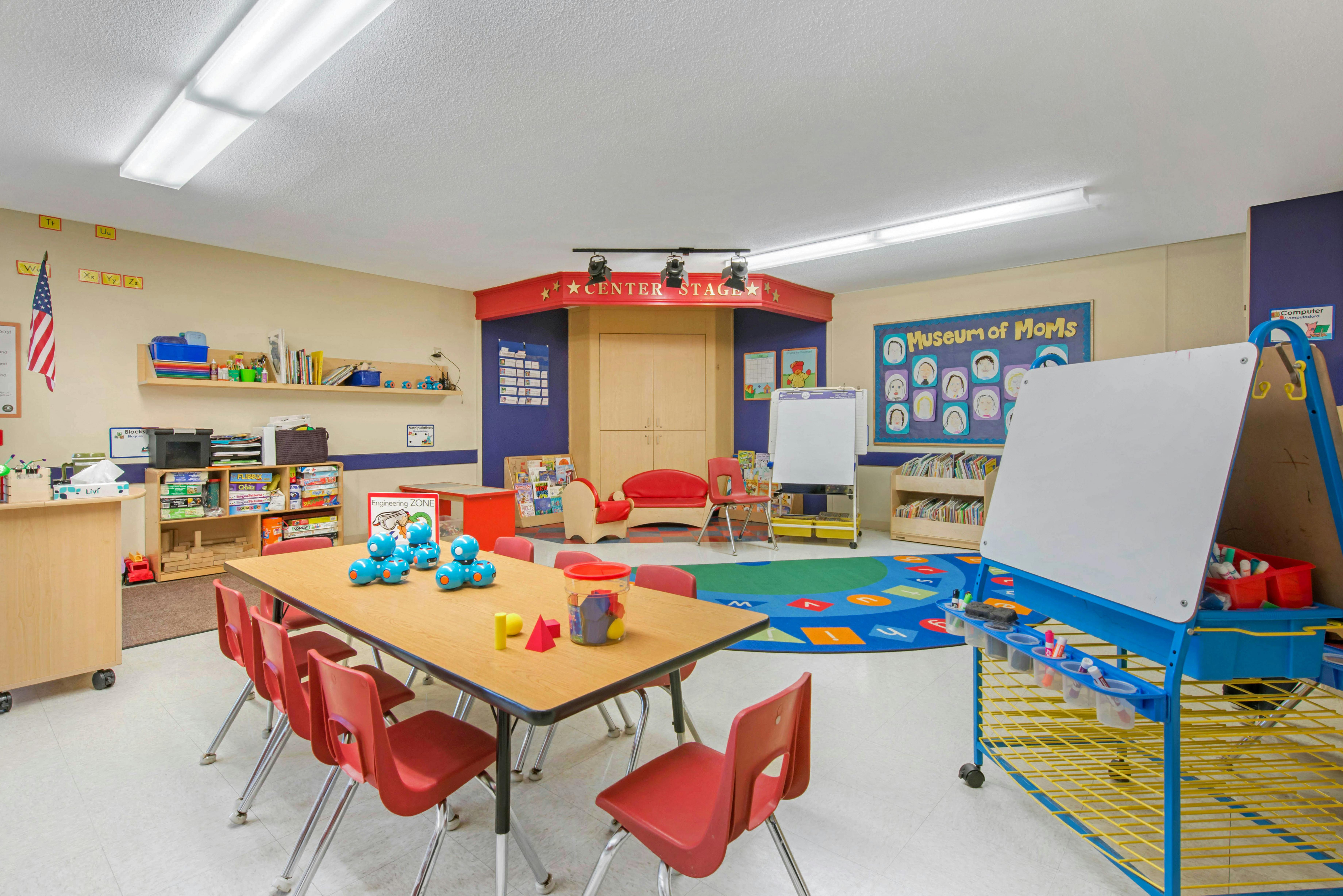 Classroom with play area, tables, and an easel