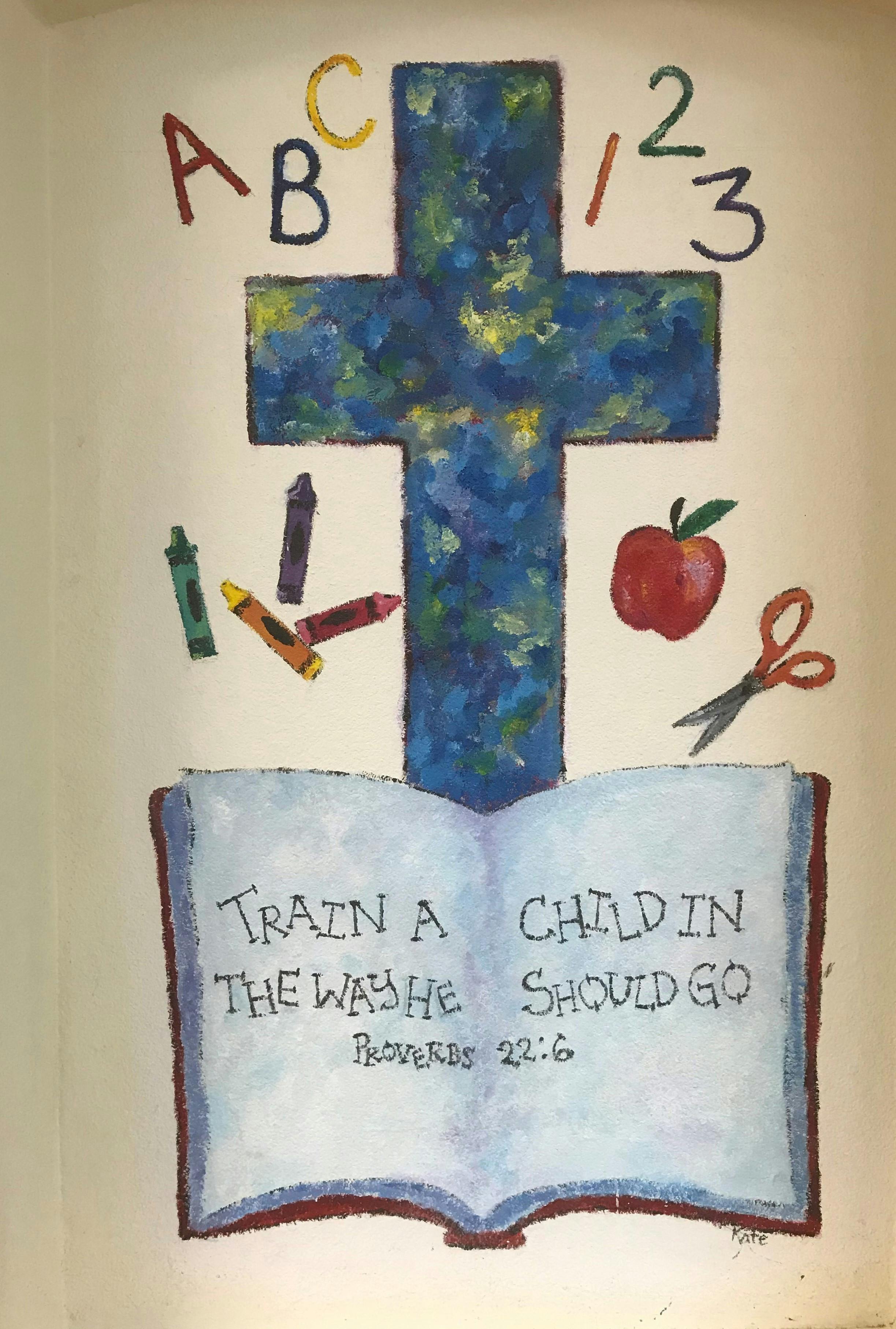 Painting of a cross, ABCs, 123s, crayons, apple, scissors, and open book