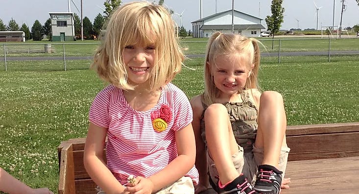Two children sitting outdoors