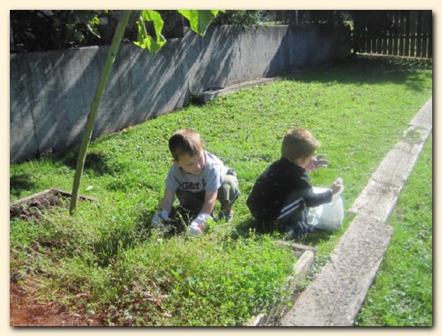 Two children crouching in grass