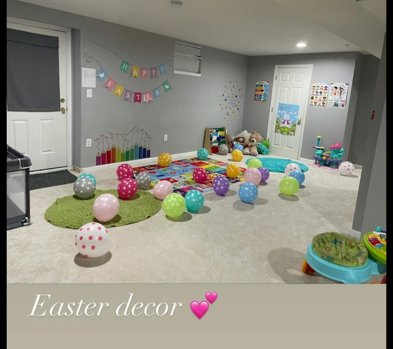 Room decorated with colorful balloons and a banner