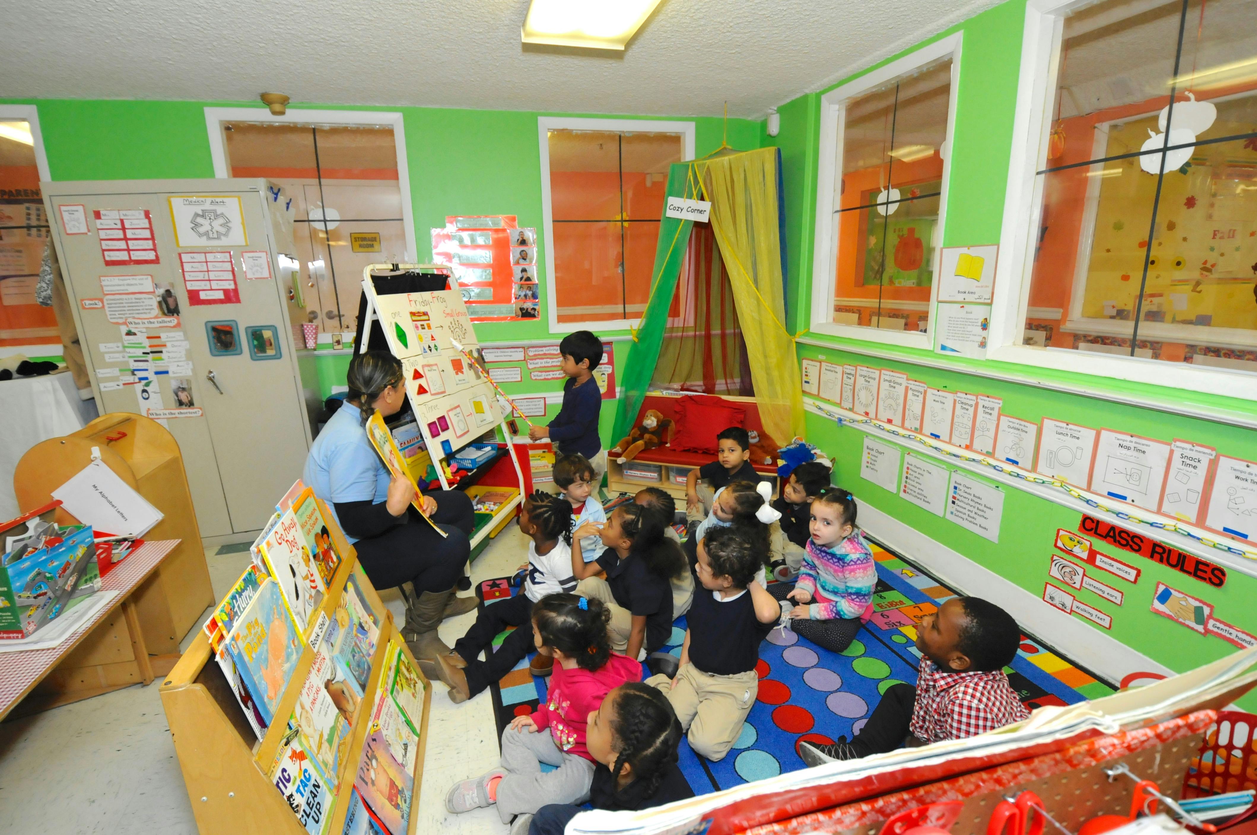Adult reading to a group of children in a classroom