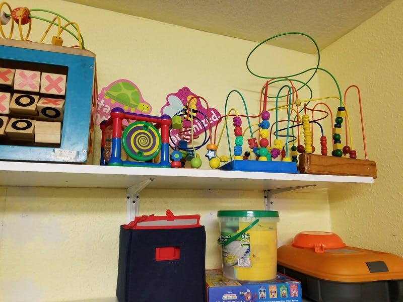 Shelf with a tic-tac-toe game and bead maze toys