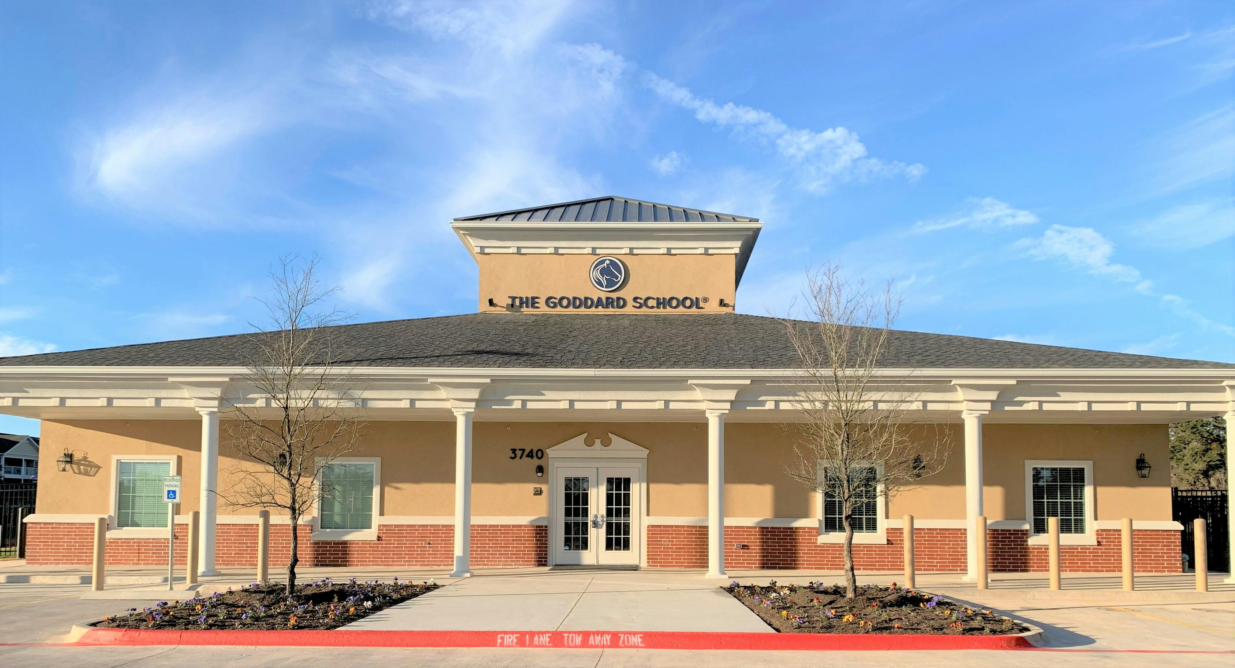 Front exterior of a school building with a sign that reads "THE NEWMAN SCHOOL"